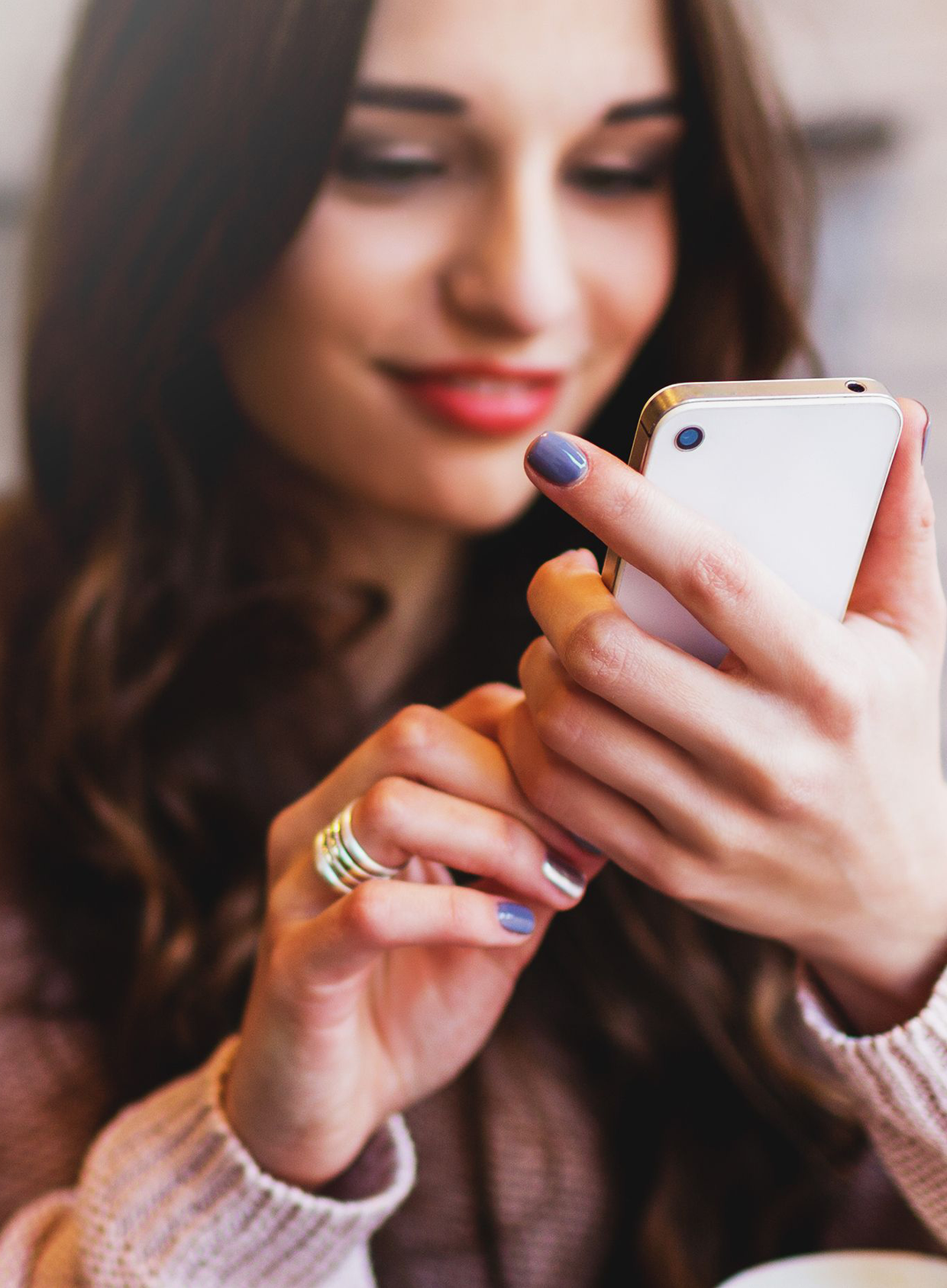 A hand holding a smartphone with Chamet app open on the screen.